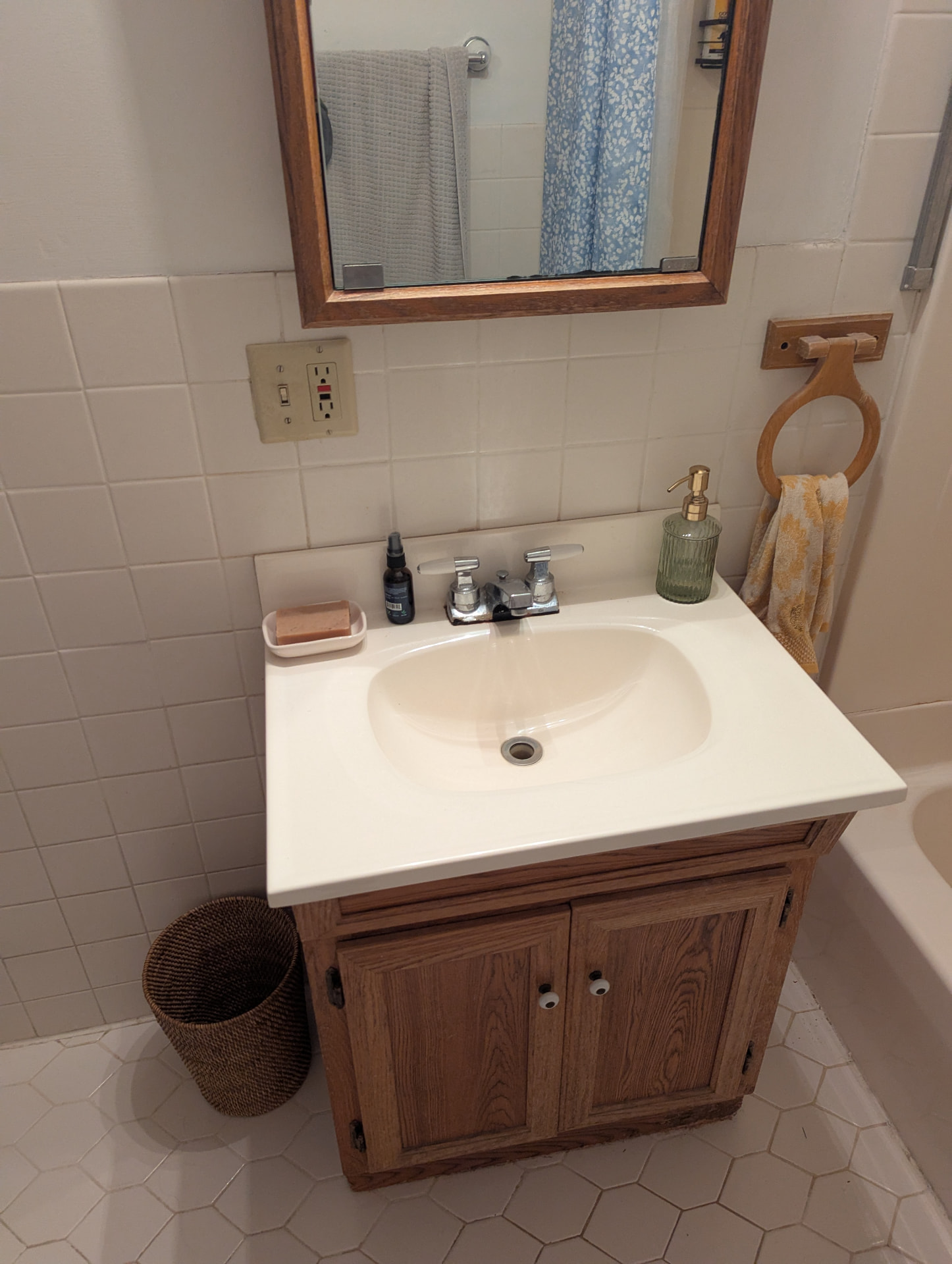Dated oak bathroom vanity with worn cultured marble top before remodel in Portland, Maine