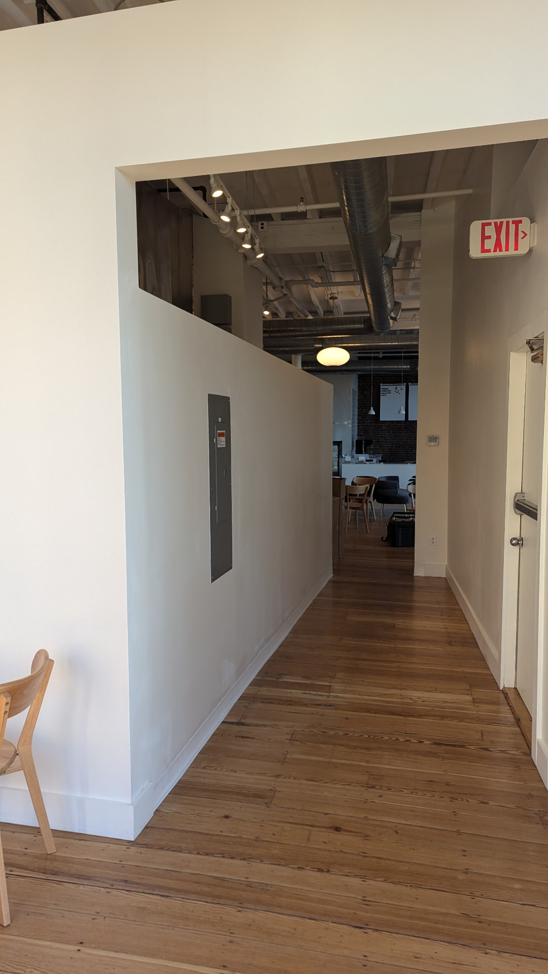 Newly built hallway with white walls and refinished wood floors in Portland, Maine