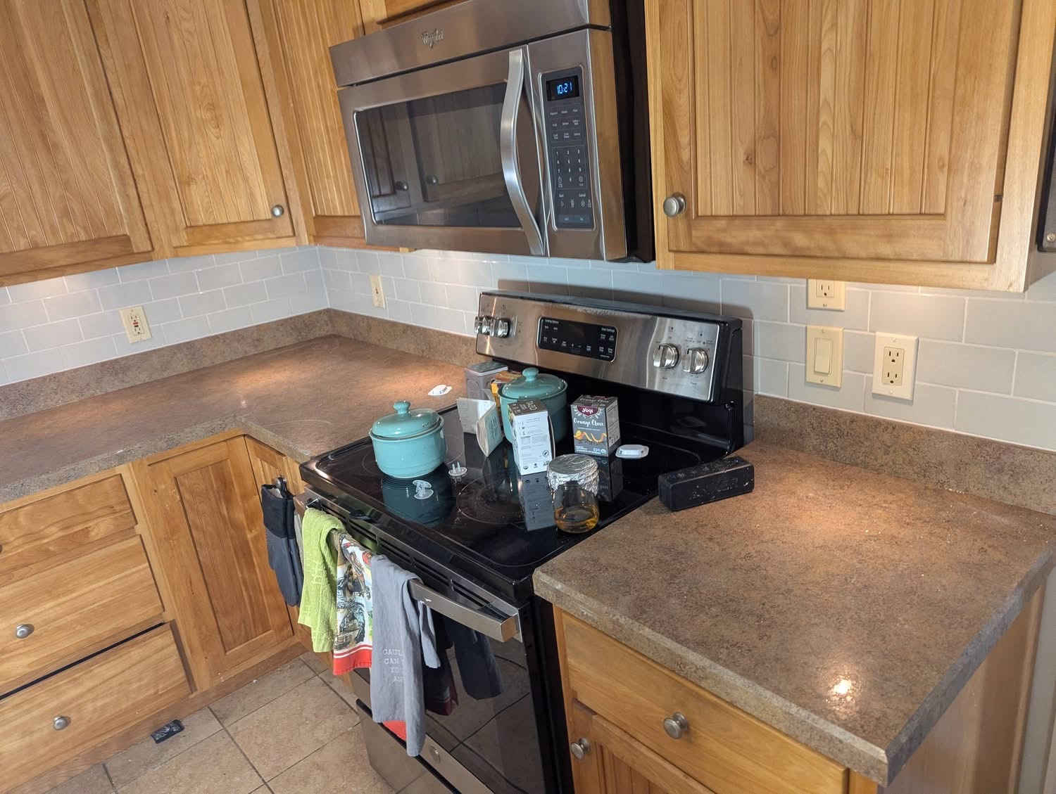 Finished white subway tile kitchen backsplash with dark grout lines in Portland, Maine