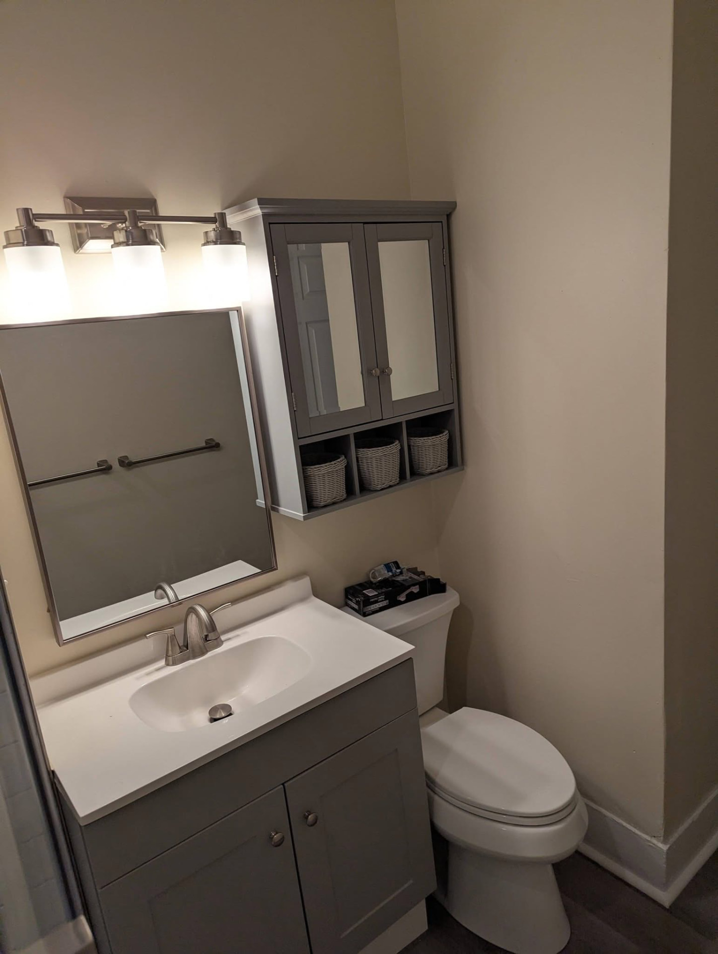 Full bathroom refresh with gray vanity, framed mirror, and medicine cabinet in Southern Maine